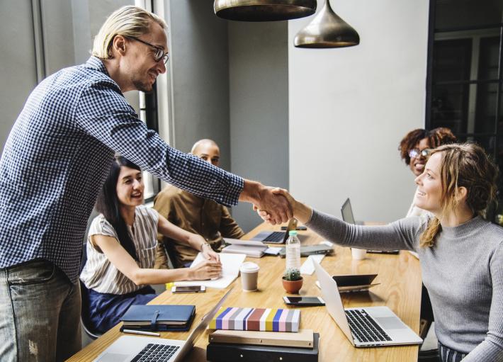 Photo of people agreeing to a mutually beneficial future at the table